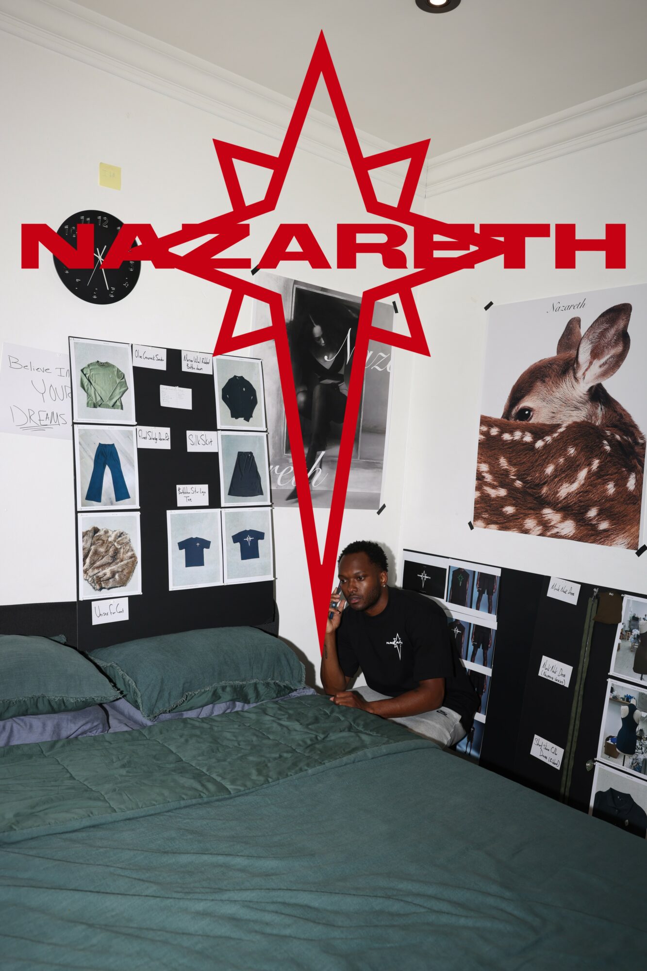 Person sitting on bed in room with posters and artwork on walls, including a rabbit and geometric designs.