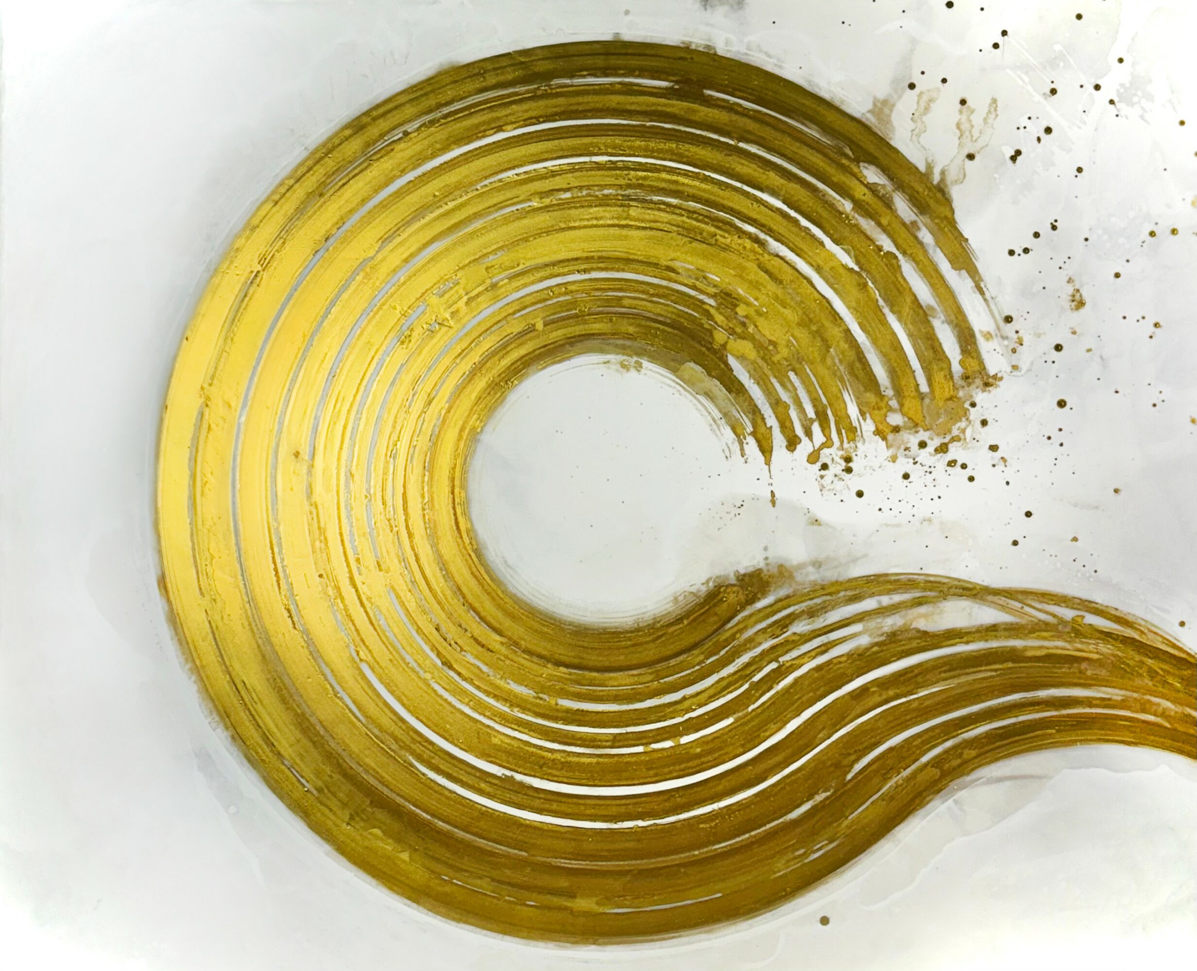 Golden spiral with concentric curved lines on white background, some paint splatters around the edges.