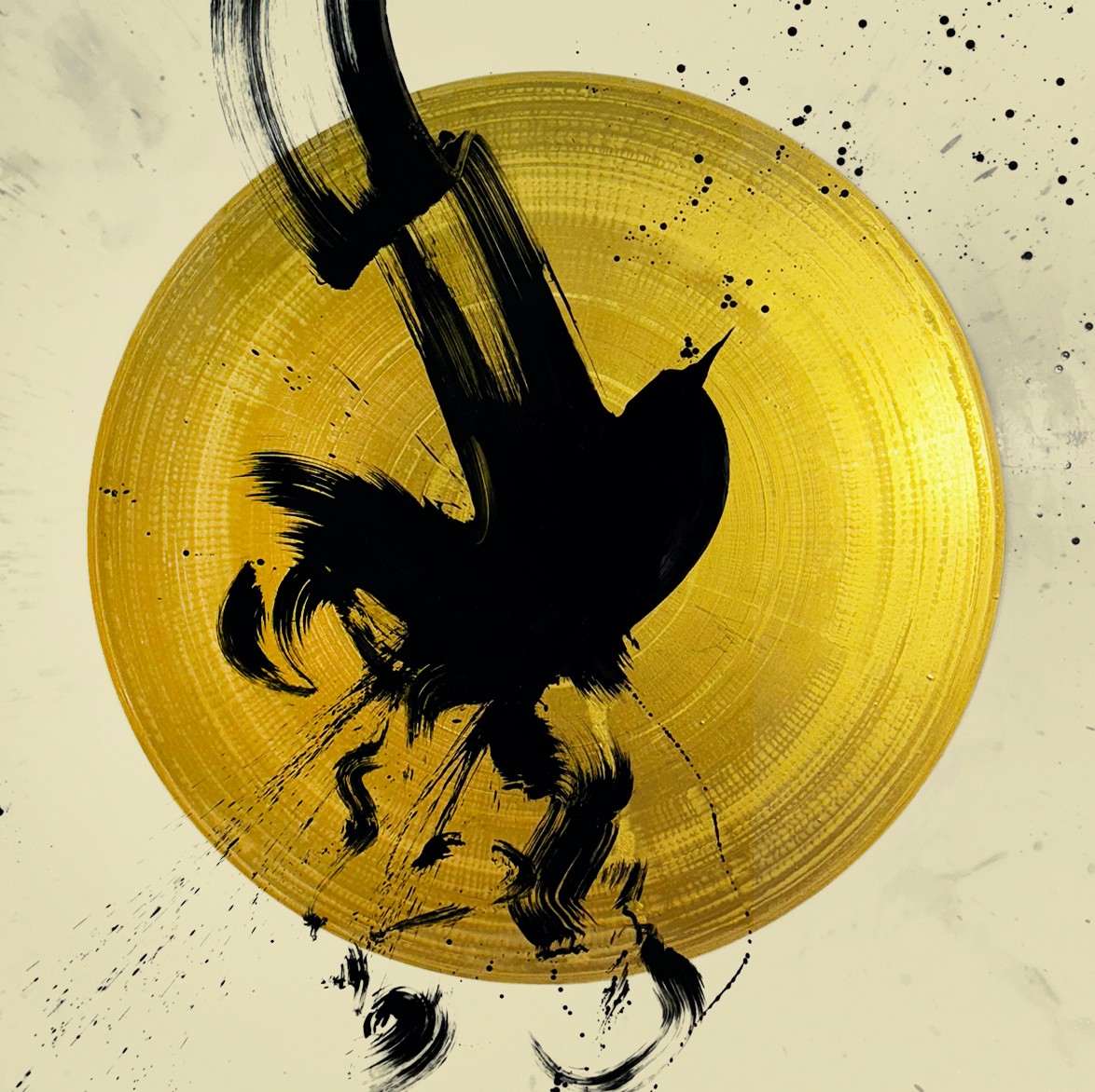 Abstract black ink splash on a yellow circular background with splatters and streaks.