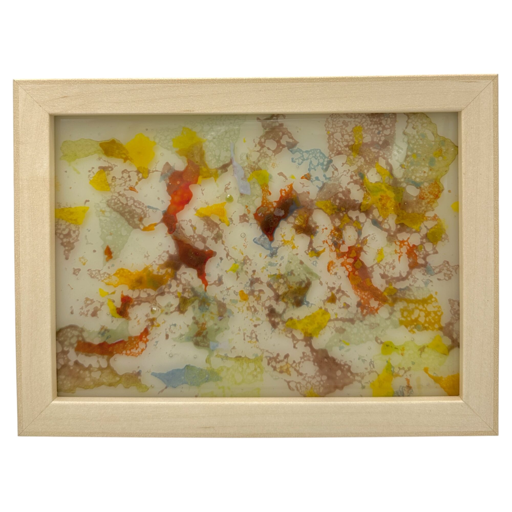 Abstract colorful pattern with yellow, red, blue, and brown splotches in a wooden frame.