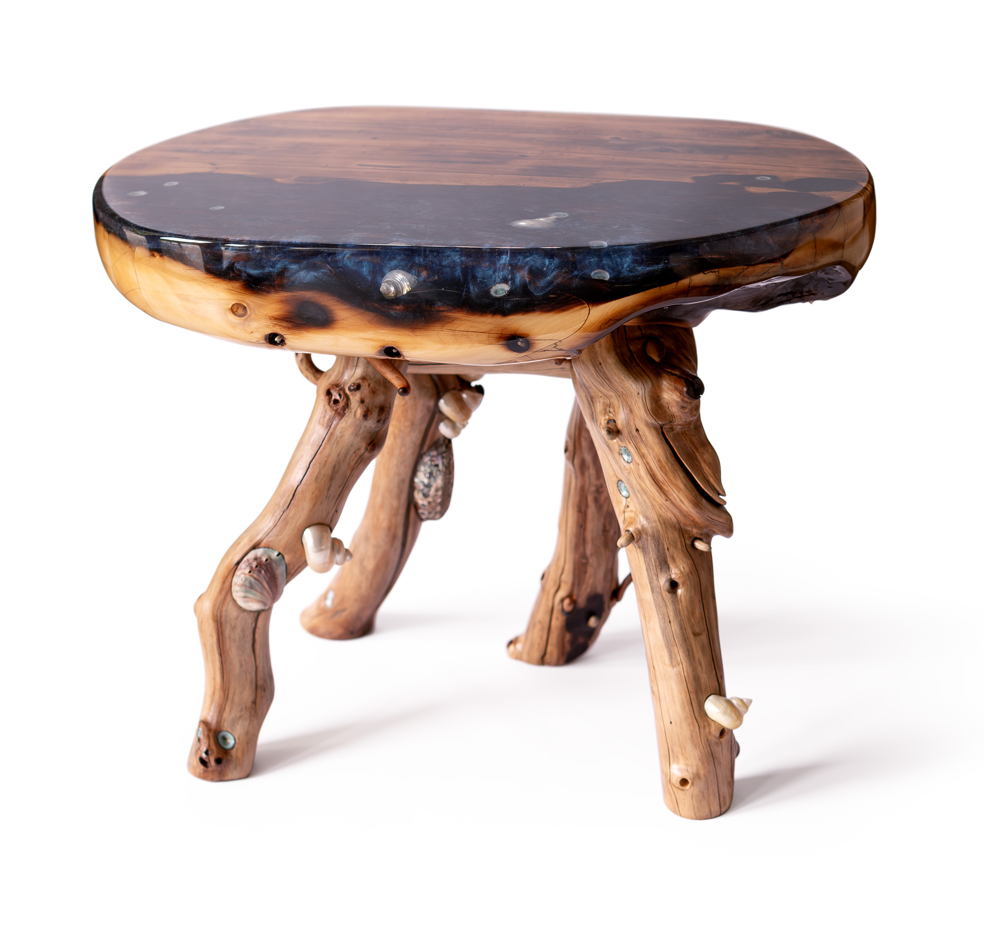 Round wooden table with a polished dark top and natural, irregularly shaped legs.