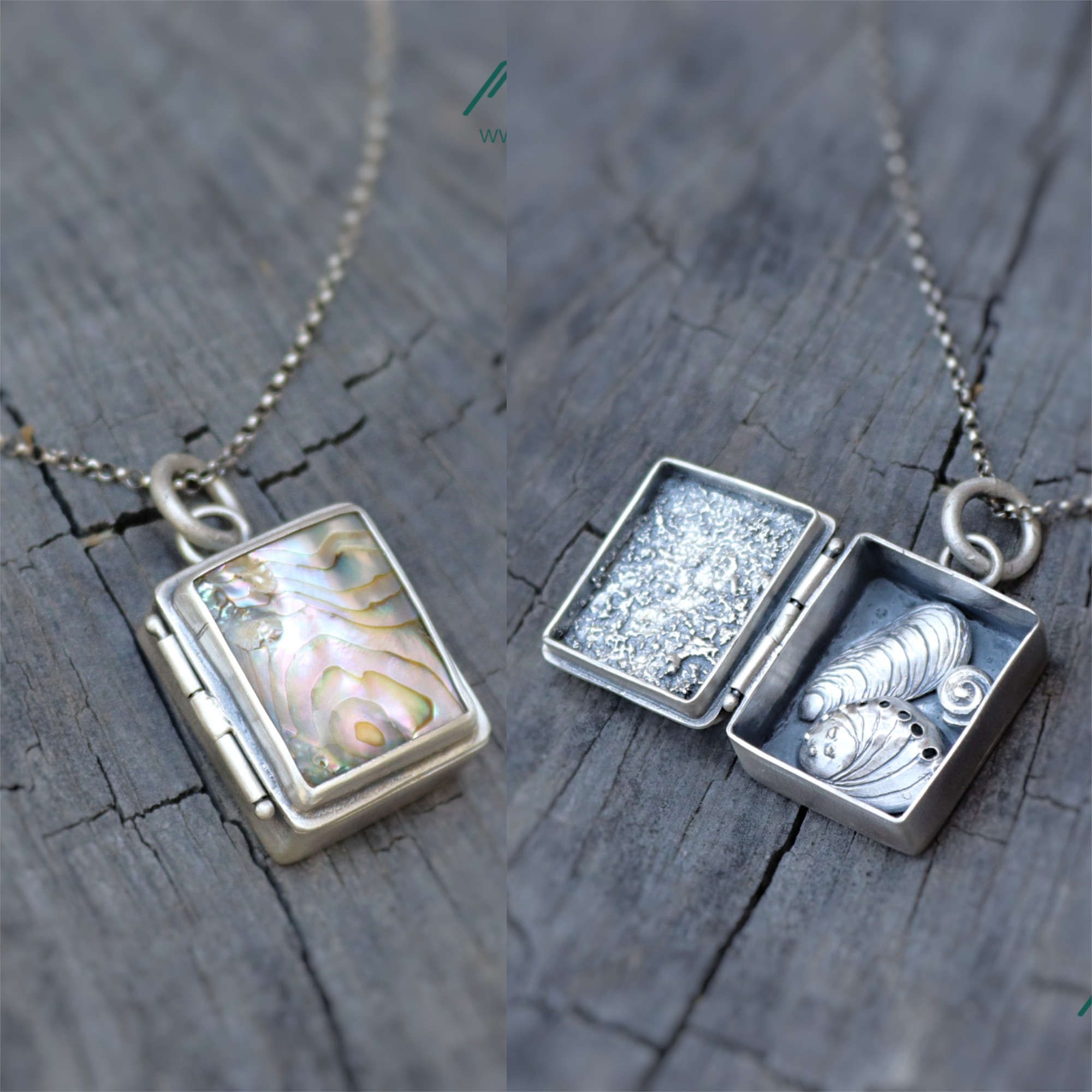 Two silver jewelry boxes with necklaces, one with a pearl-like pendant and the other with a shell design, on a wooden surface.