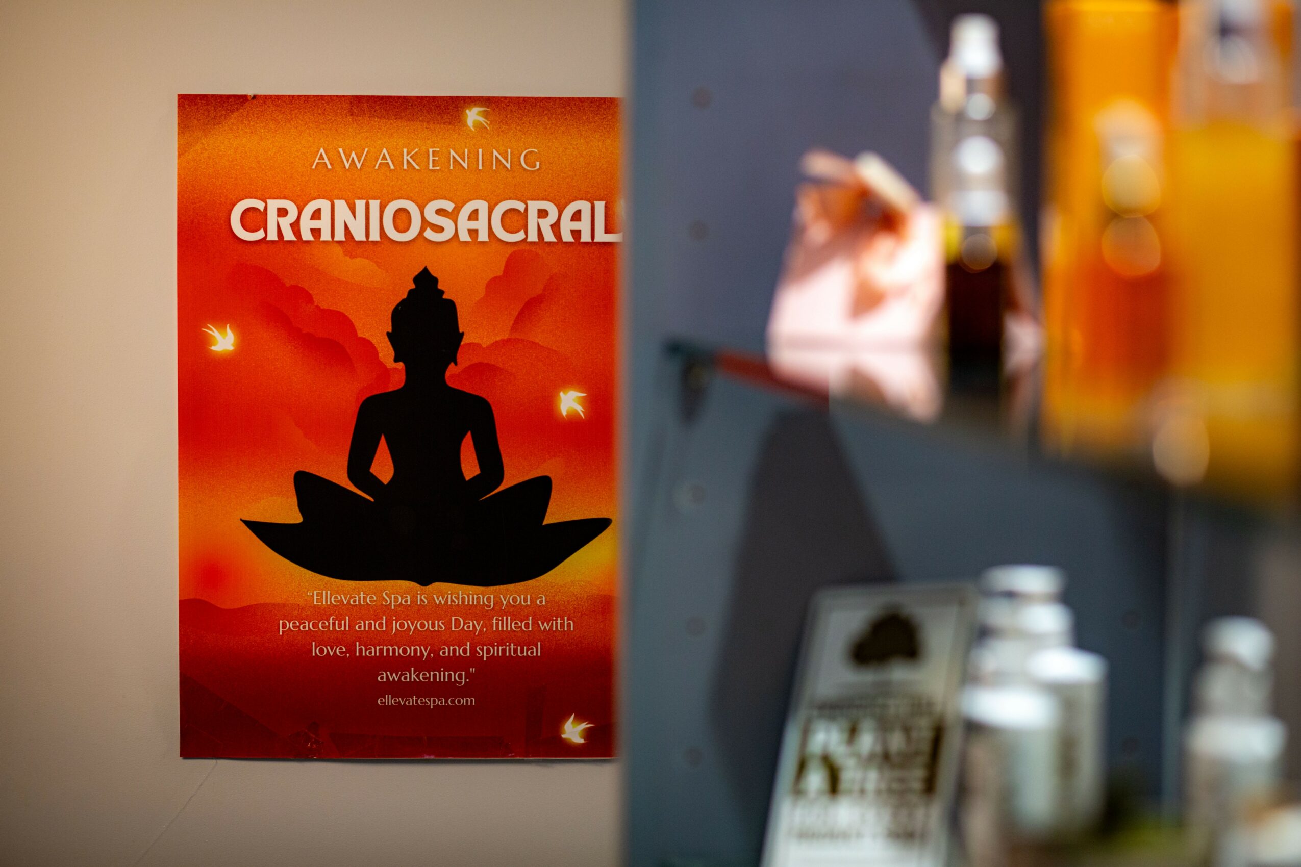 Poster with a silhouette of a person meditating against a red and orange background, with text about awakening and craniosacral therapy.