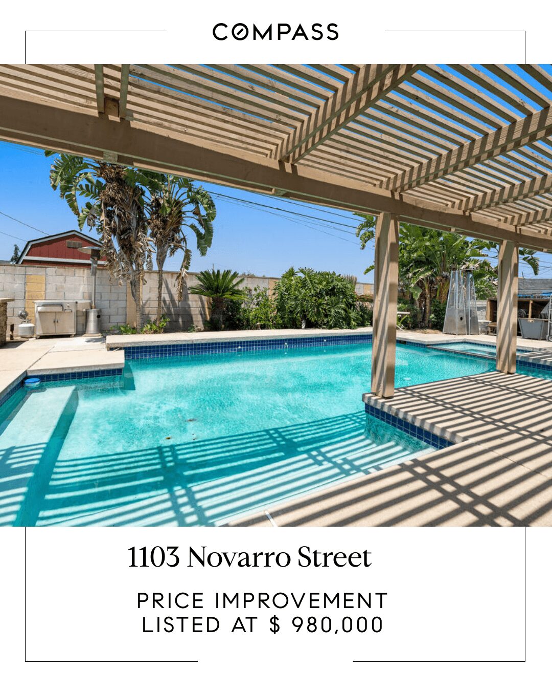 Swimming pool with shade structure, trees, and buildings in background, under a striped roof.