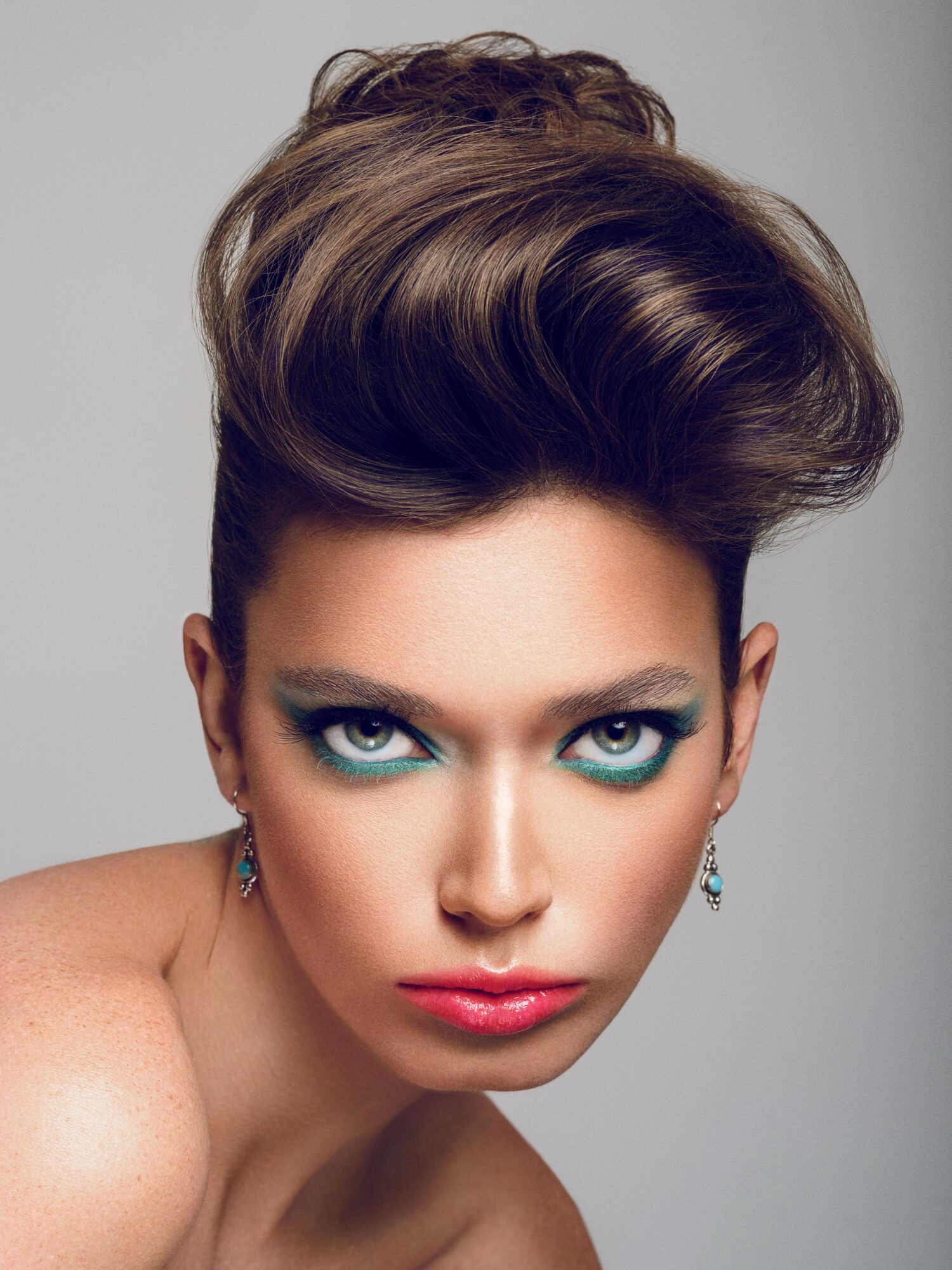 Woman with styled hair and makeup, looking directly at the camera.