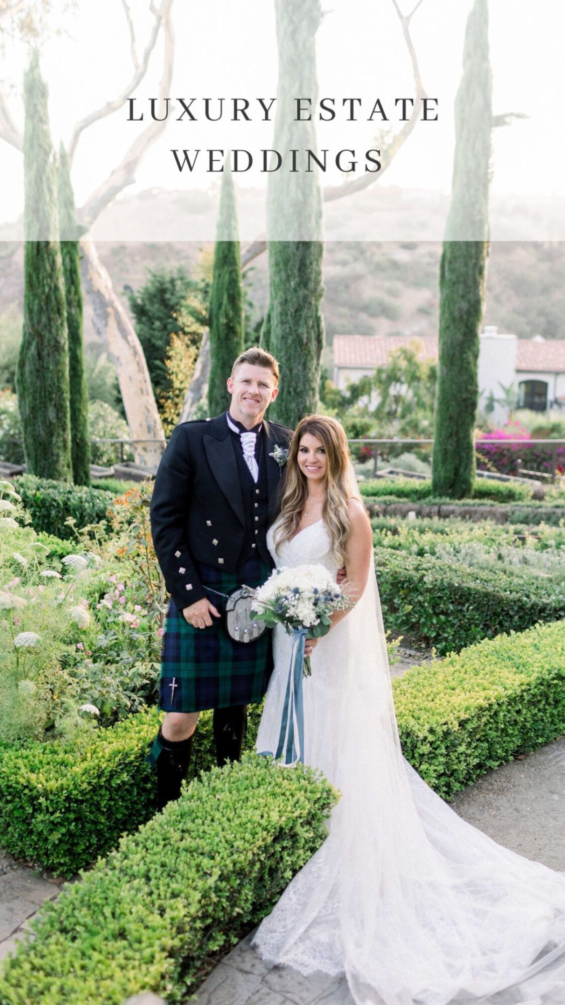 Bride and groom standing outdoors among tall trees and manicured bushes, bride holding a bouquet, wedding attire, smiling.