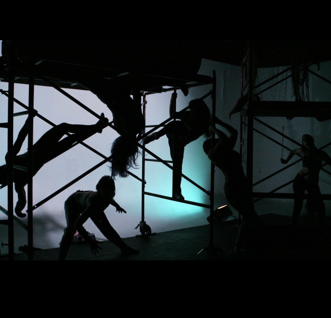 Silhouettes of children playing on a playground structure with a blue background.