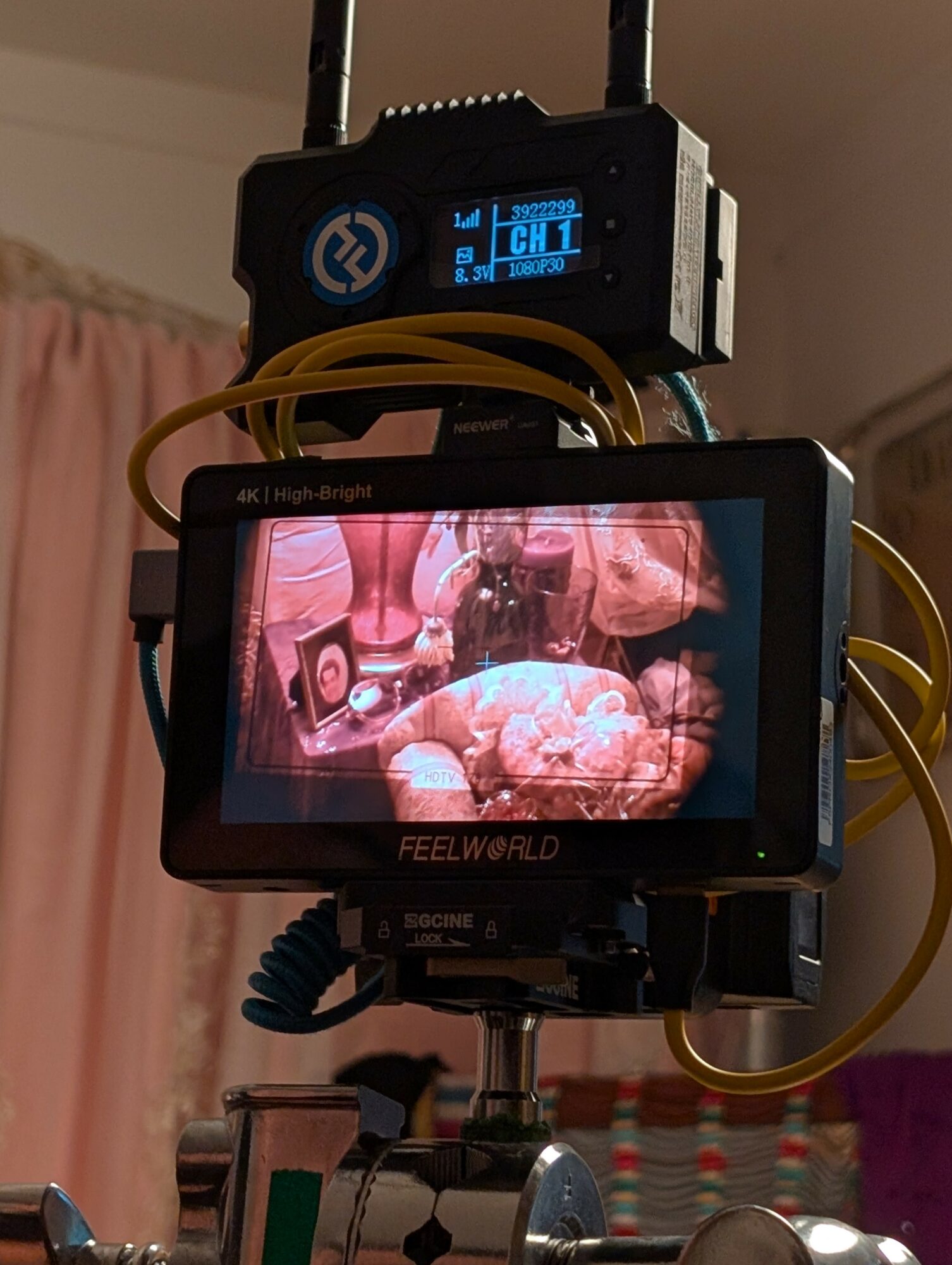 Medical monitor displaying an internal view of a surgical procedure with surgical tools and tissue.