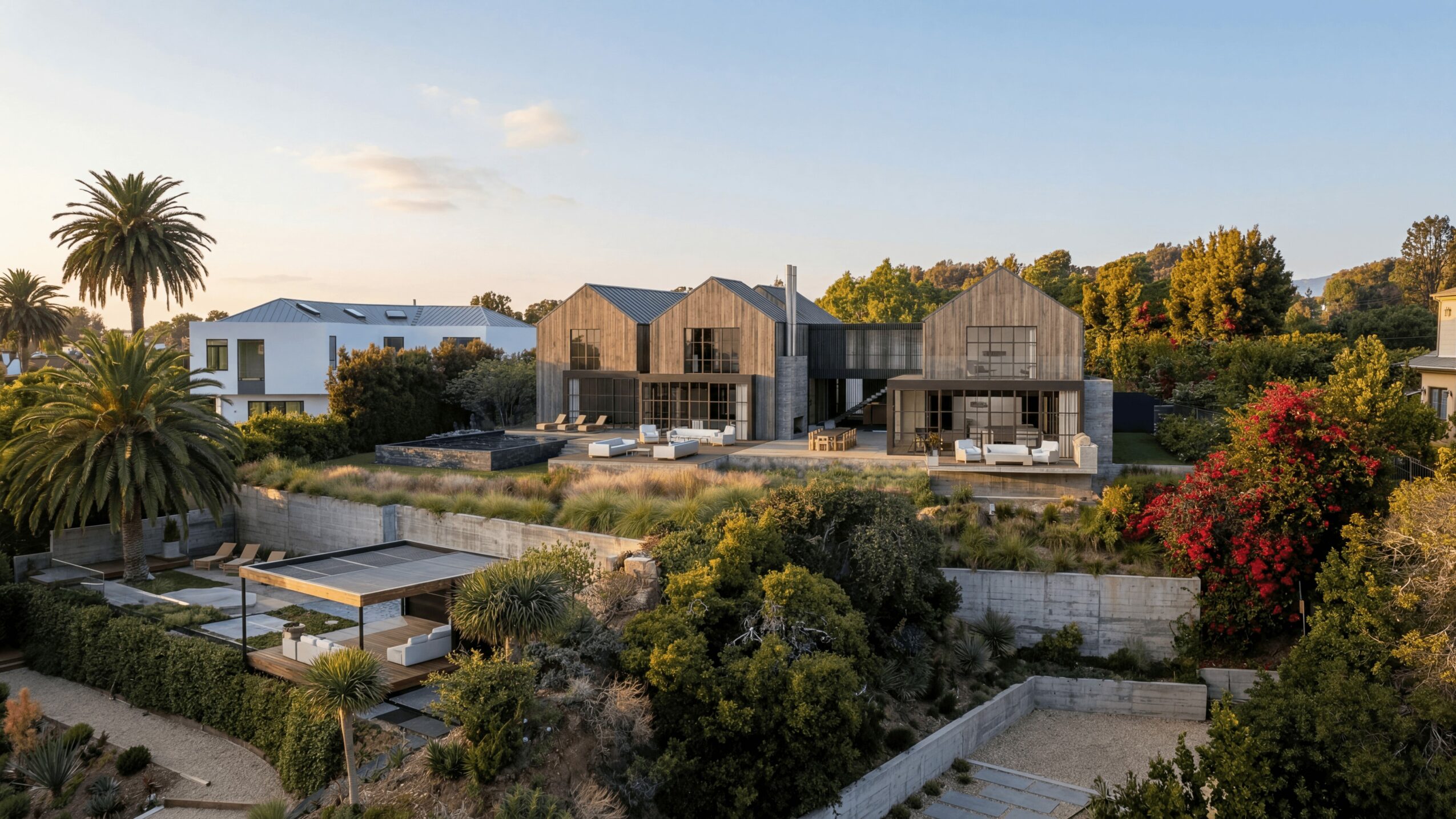 Modern houses with large windows and outdoor patios, surrounded by lush greenery and colorful trees.