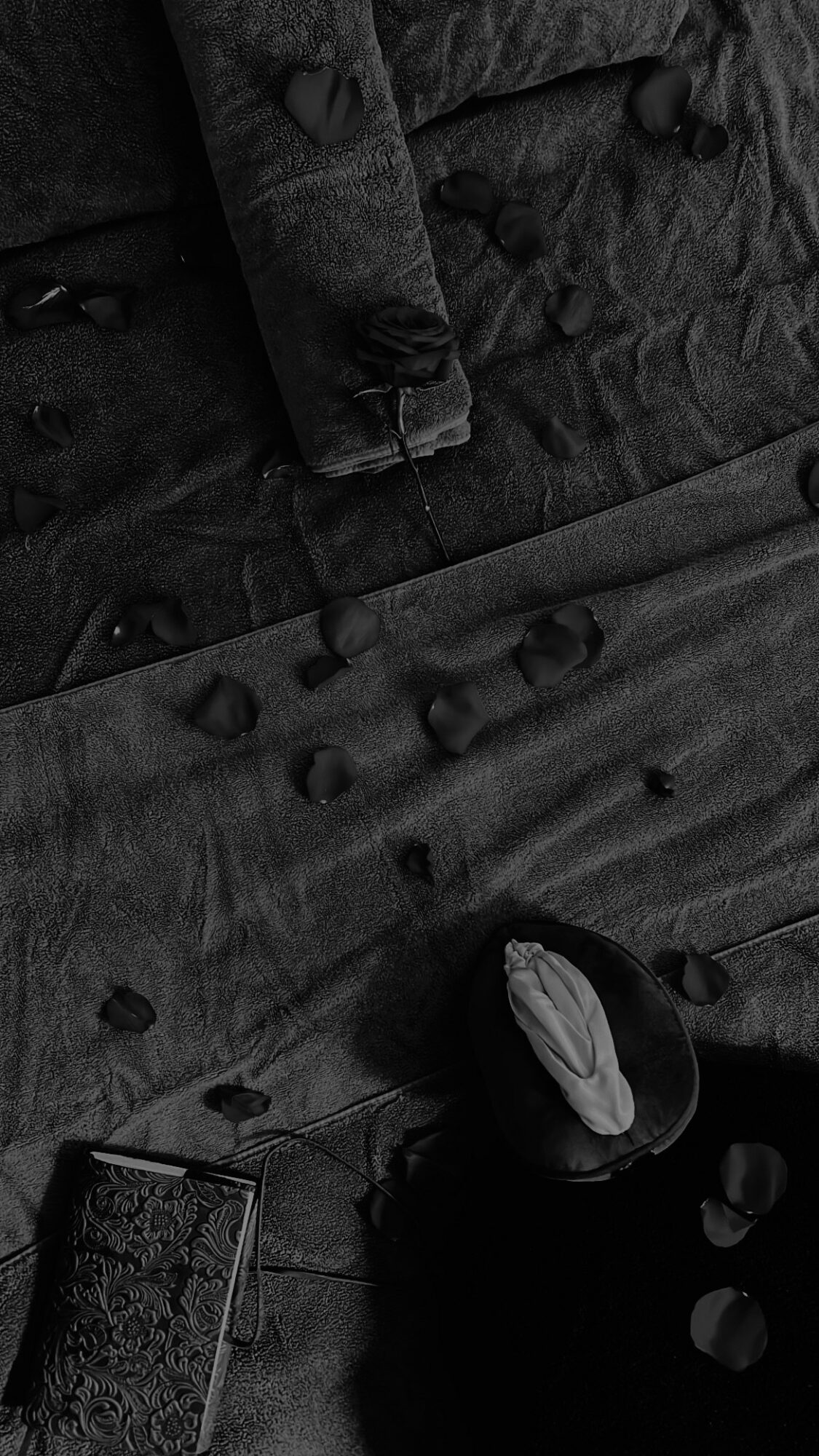 Black fabric with buttons and a partially visible black object with a white interior.