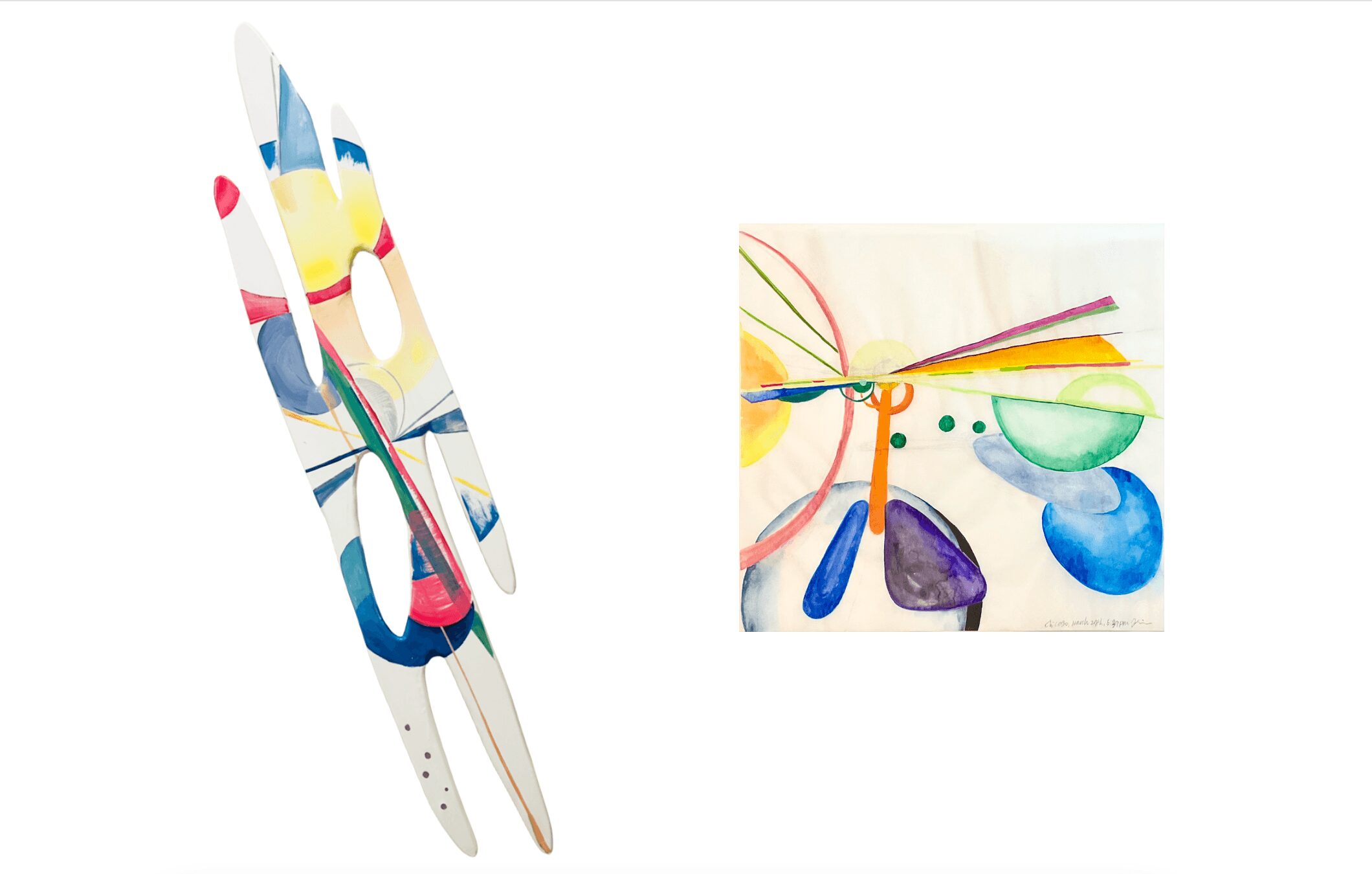 Two paintbrushes and a colorful abstract painting on paper with various shapes and lines.