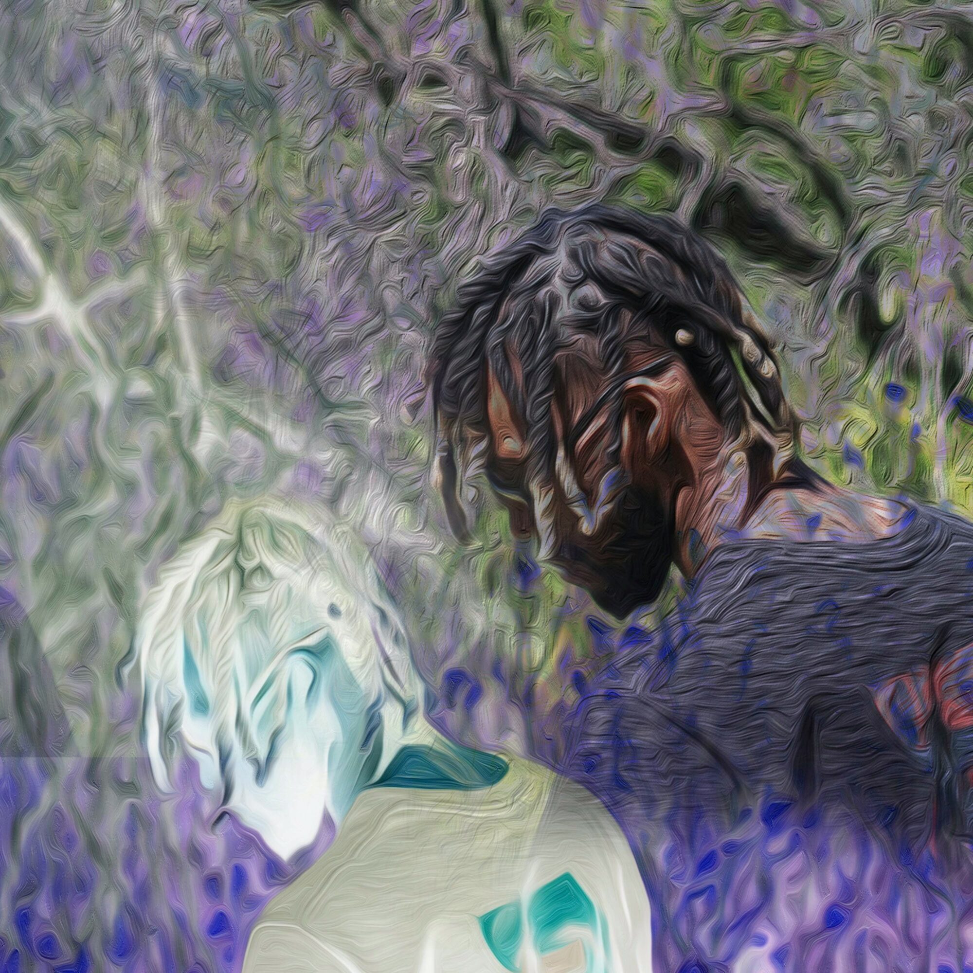 Person with dreadlocks and a beard, wearing a dark shirt, in a natural outdoor setting with purple and green foliage.