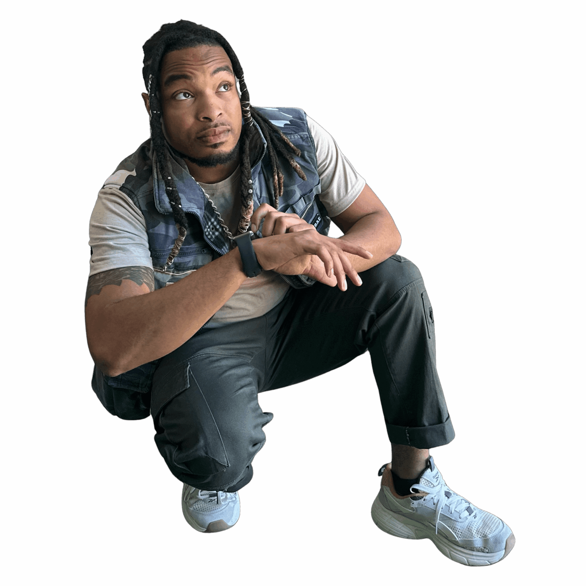 Person crouching with hands clasped, wearing a vest, t-shirt, pants, and sneakers, against a black background.