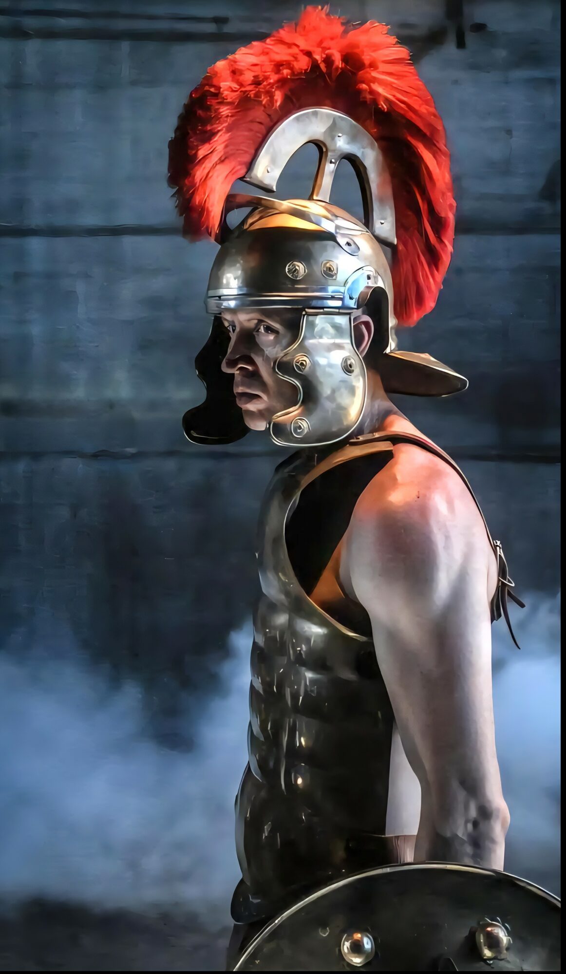 Person in Roman-style helmet with red plume, armor, and shield, standing in smoky environment, facing sideways.