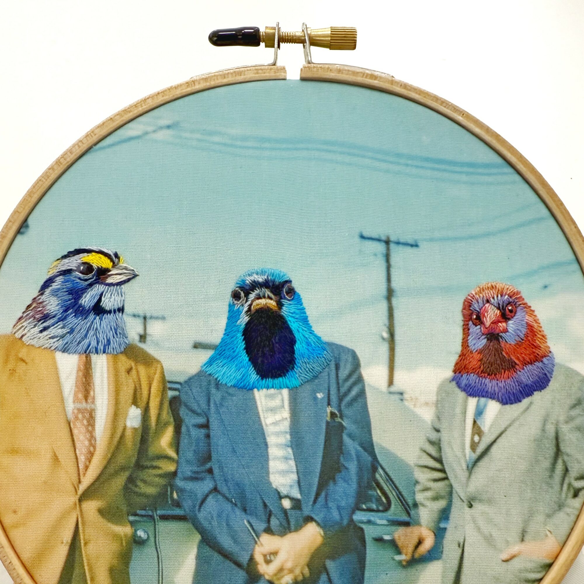 Three people with bird heads in suits standing outdoors on a street with power lines.