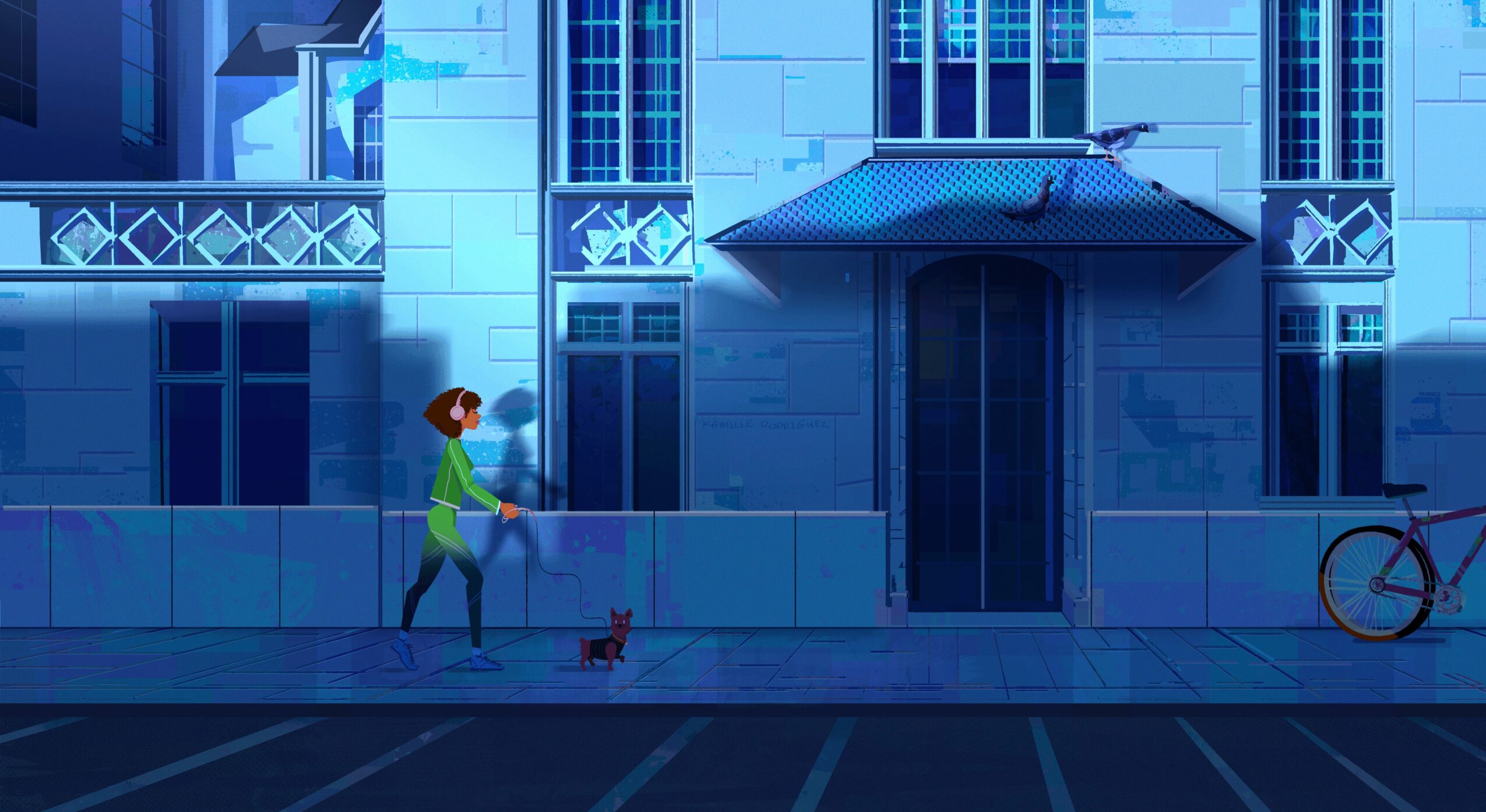 Person walking a small dog on a city sidewalk at night, with a bicycle nearby and a large building in the background.