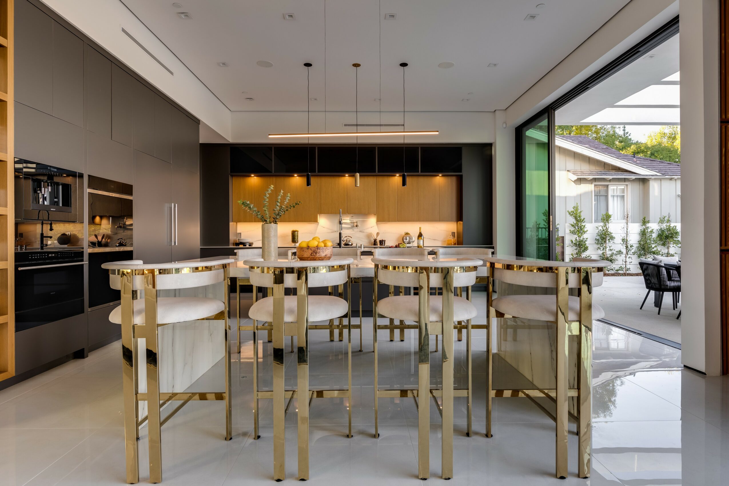 Modern dining room with a large table, chairs, and a sliding glass door leading outside.