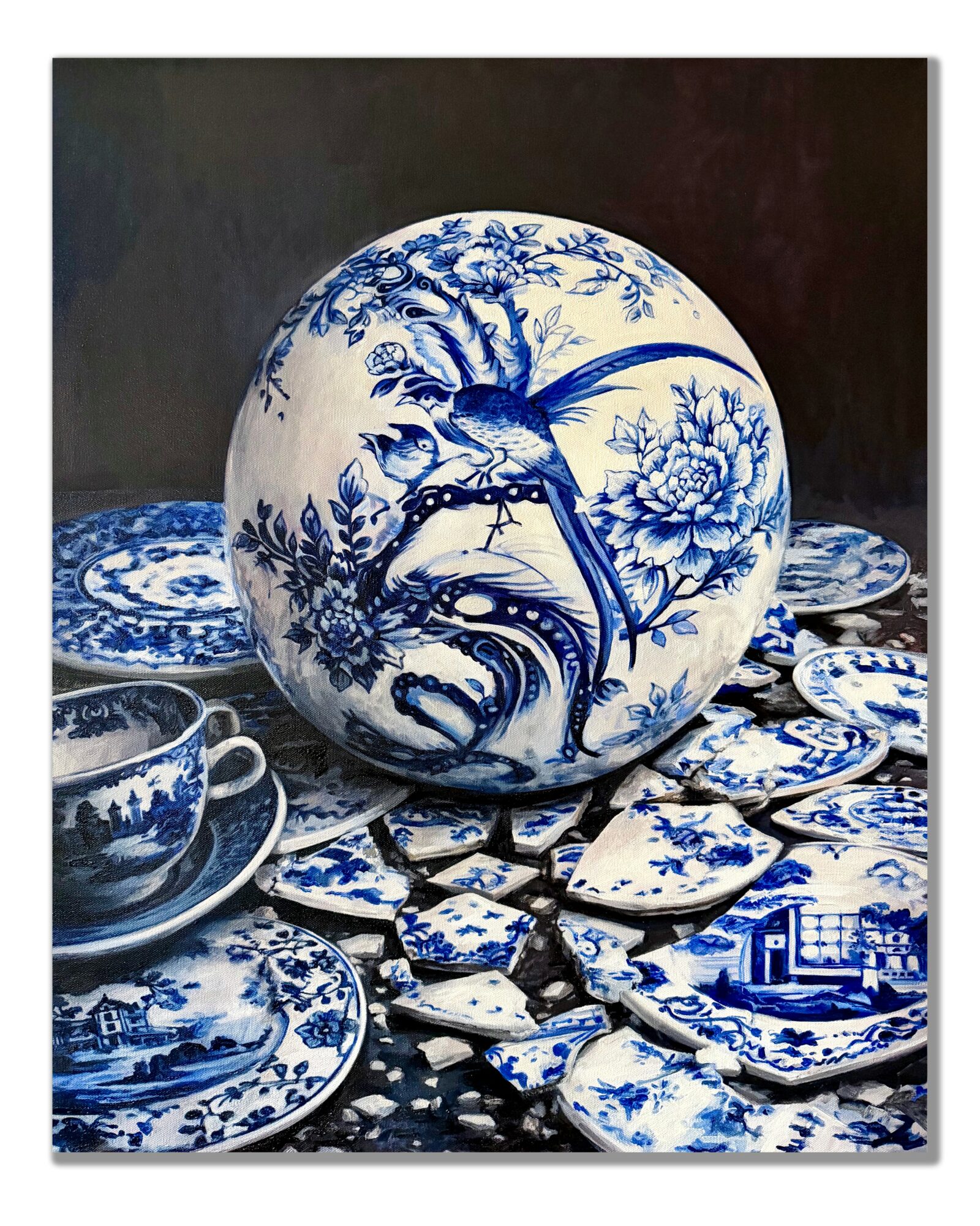 Decorative blue and white porcelain plate with a bird and floral design, surrounded by matching dishes and broken pieces, on a dark background.