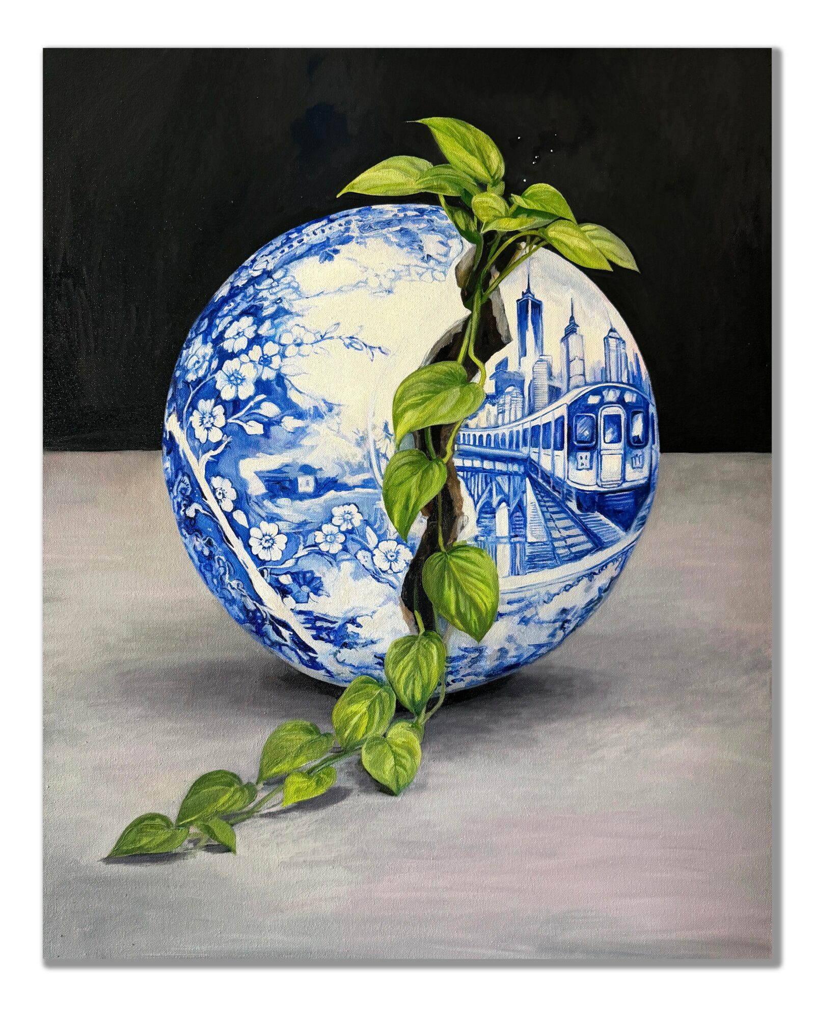 A blue and white patterned ceramic bowl with a green vine draping over it, set against a dark background.