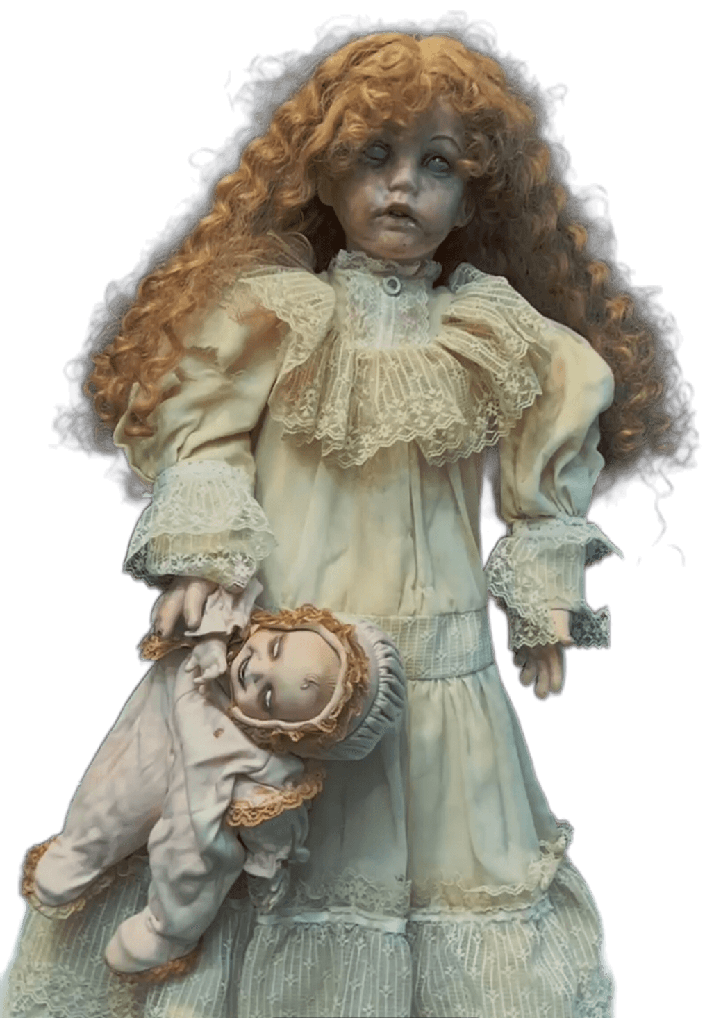 Porcelain doll with curly hair wearing a vintage cream dress, holding a smaller doll, against a black background.