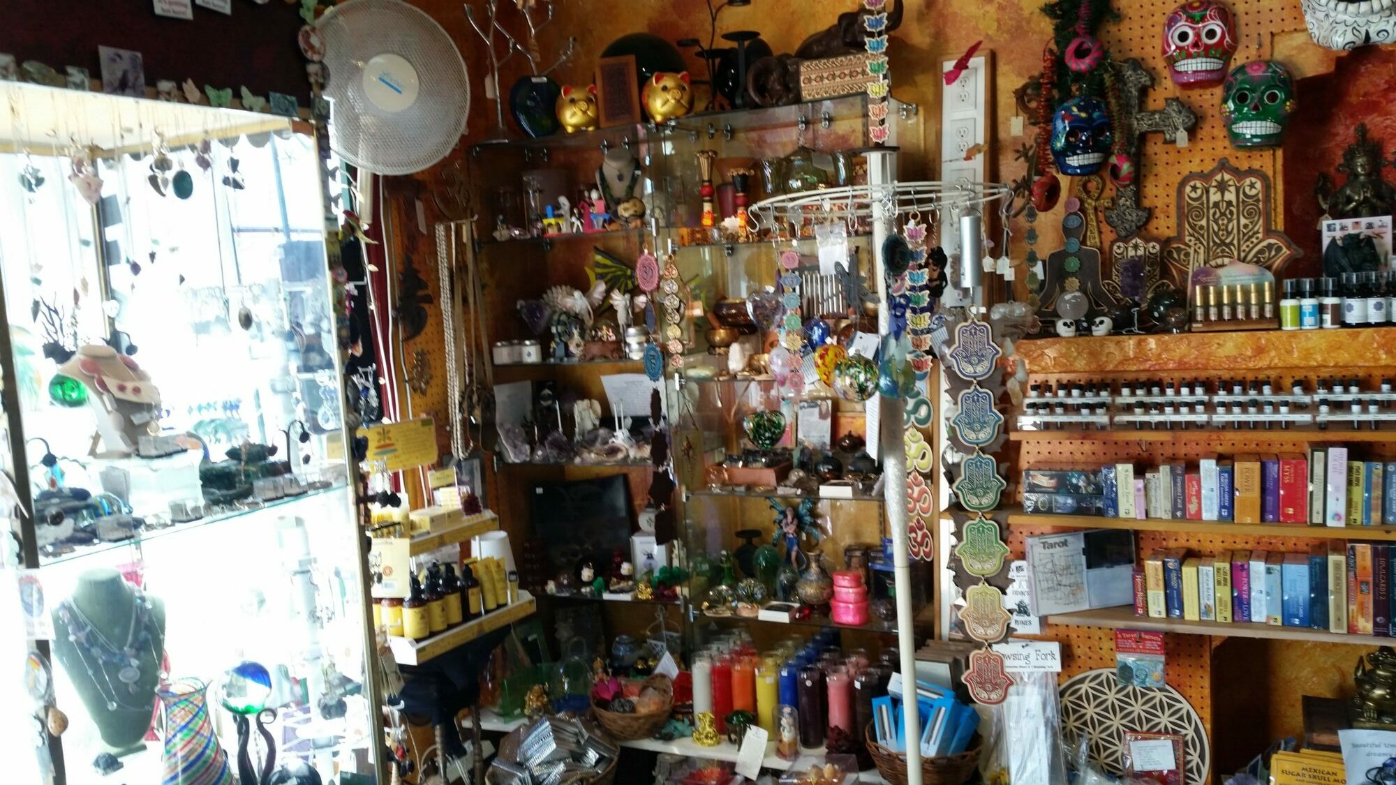 Interior of a shop with shelves filled with various colorful items, including toys, books, and decorative objects.