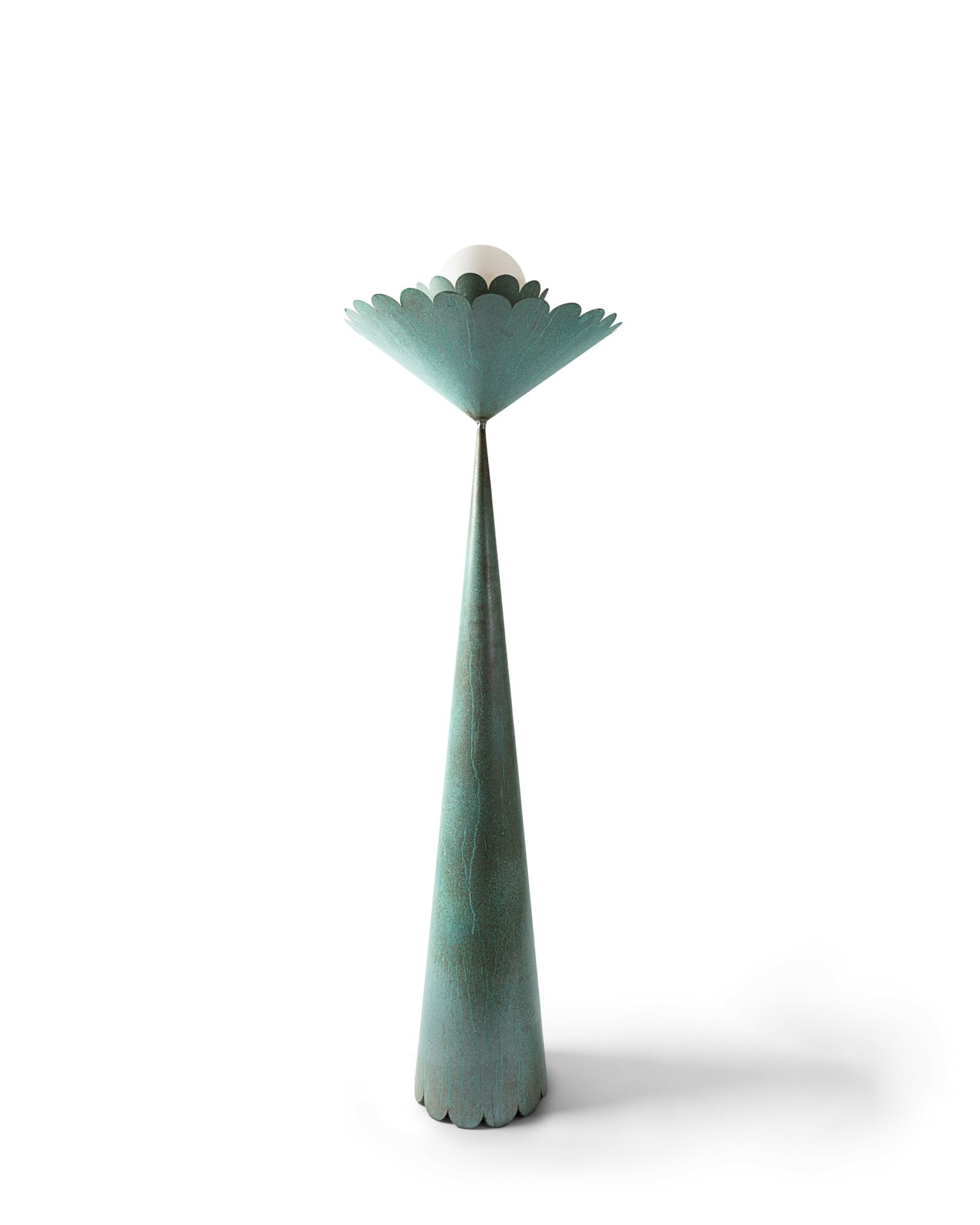 A tall, narrow, teal-colored object with a scalloped top and a rounded base, standing upright on a white background.